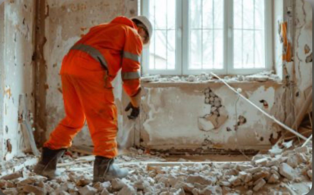 Worker performing controlled interior demolition